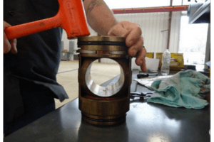 Man hammering on a 2 piece cannister valve