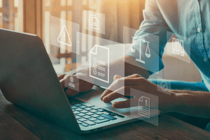 Man on laptop with computer graphics floating representing M&M International's Privacy Policy